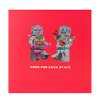 Two robot figures holding hands on a red background with 'Made for Each Other' text.