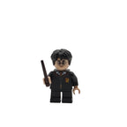 LEGO figure of a character in a black outfit with glasses and a wand on a white background