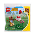 LEGO Animal Crossing set packaging with character and items on a scenic background