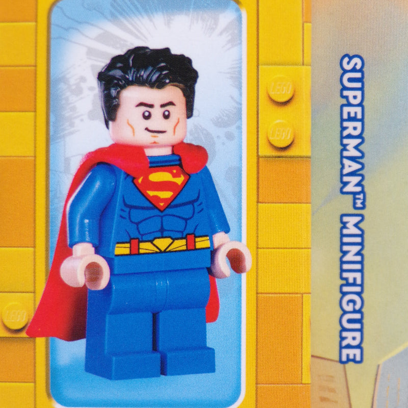 Superman minifigure on a yellow and blue background