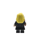 Toy figure with blonde hair and a black outfit on a white background