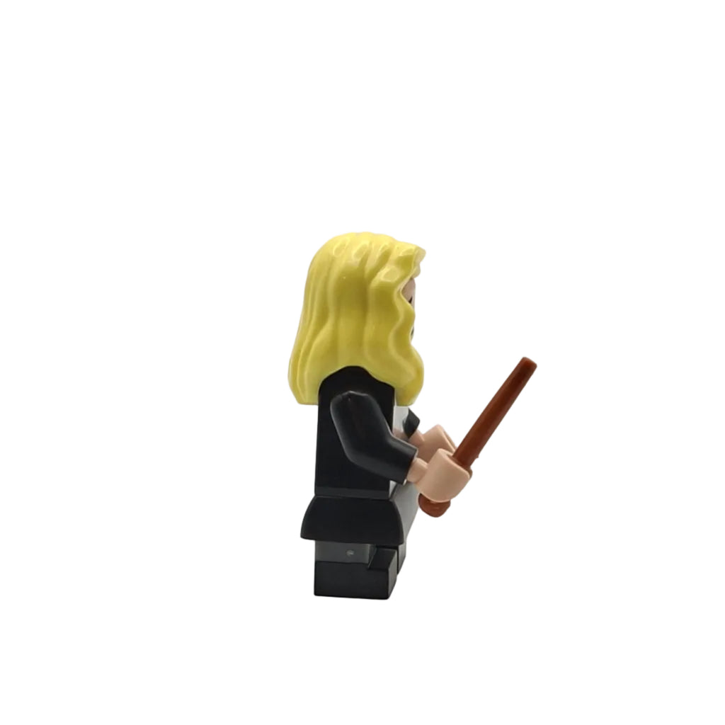 Toy figure with blonde hair and a wand on a white background