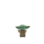Green and brown toy figure on a white background