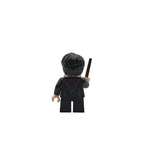 Black LEGO figure with helmet and staff on a white background