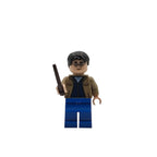 LEGO figure of a character with glasses and a robe holding a wand on a white background