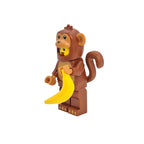 Toy monkey figure with a banana on a white background