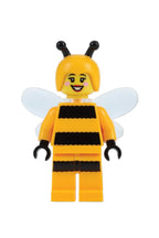 LEGO bee minifigure with yellow body, black stripes, and white wings on a gradient background