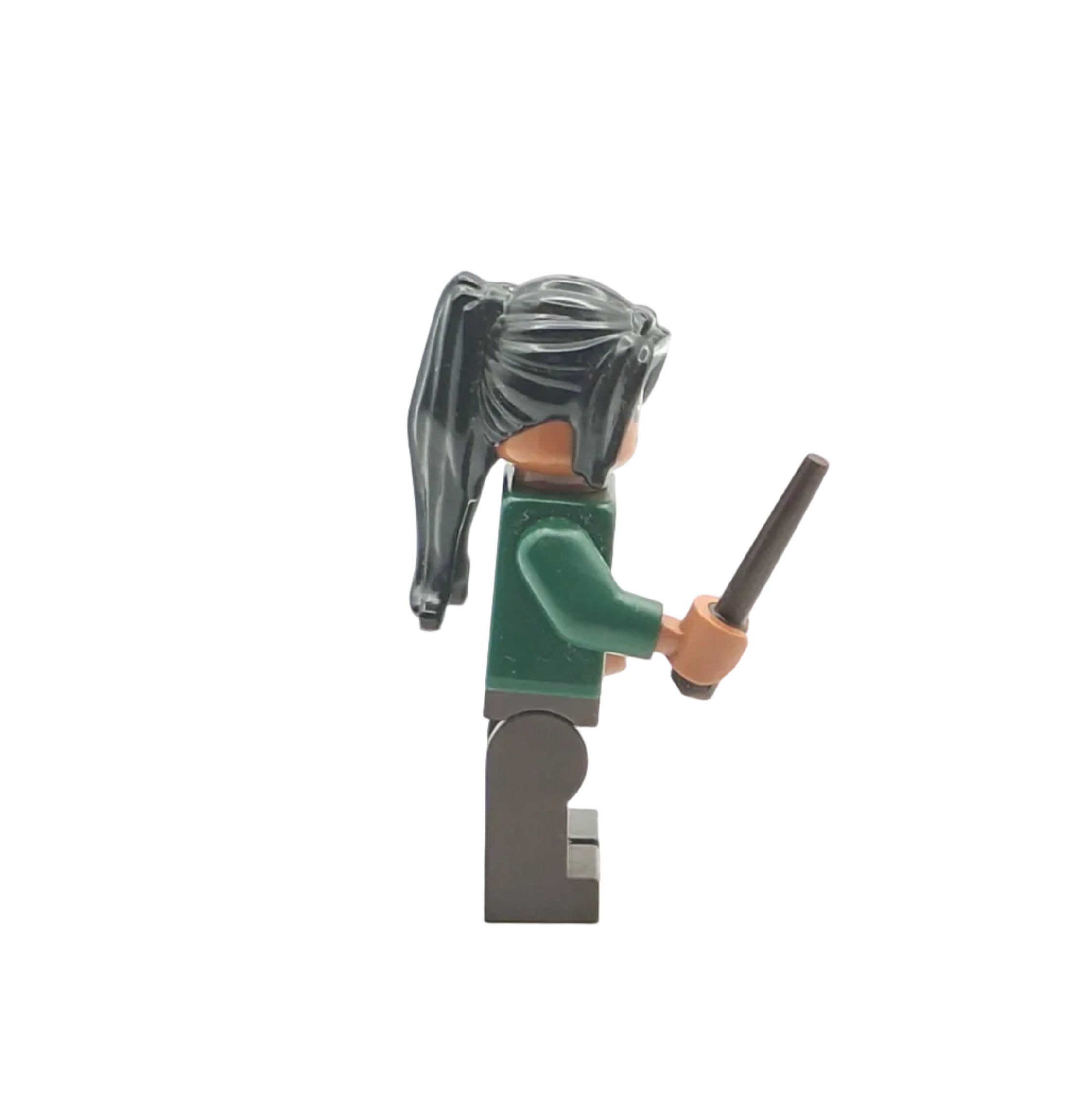 Toy figure with green outfit and black staff on a white background